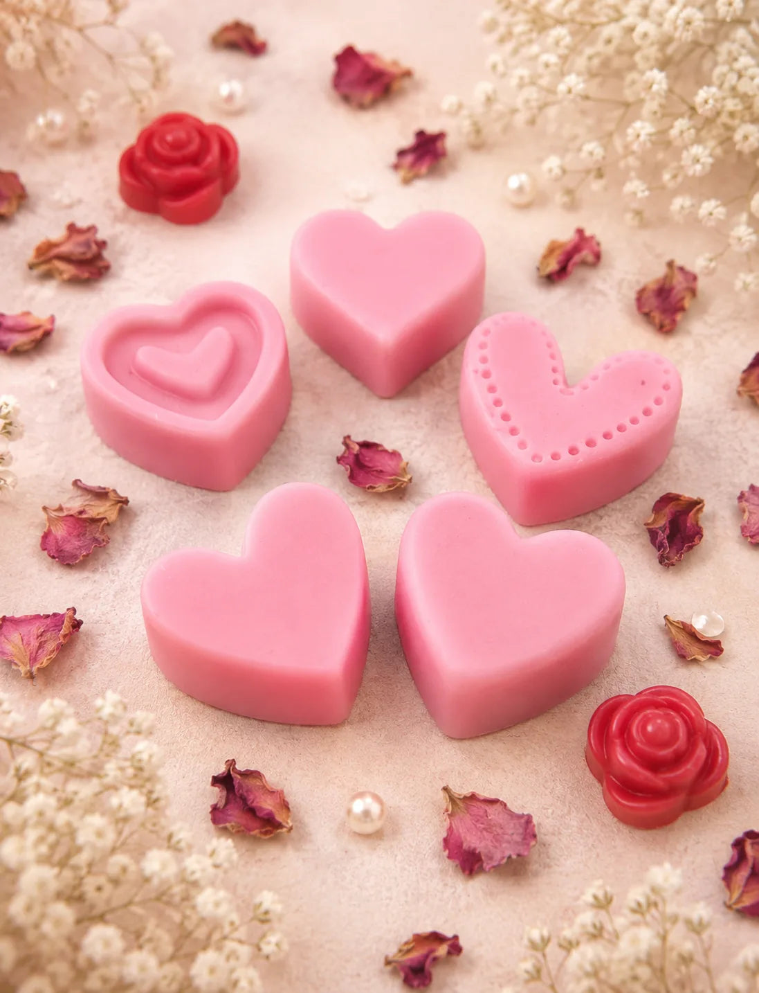 Pink heart-shaped wax melts with red rose wax melts and dried petals