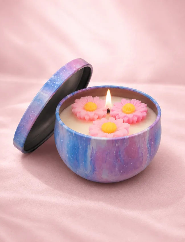 Pear Freesia Bloom soy candle in a blue and purple marbled tin with pink flower wax decorations