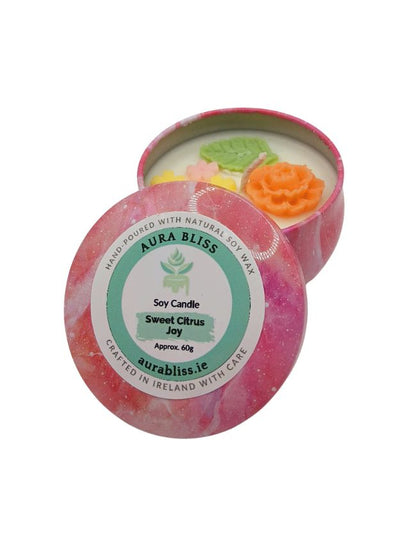 Aura Bliss Sweet Citrus Joy soy candle in decorative tin with floral wax decoration