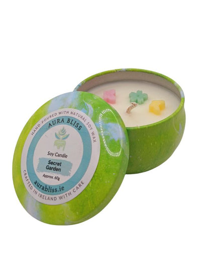 Secret Garden soy candle in decorative tin with flower-shaped wax decoration