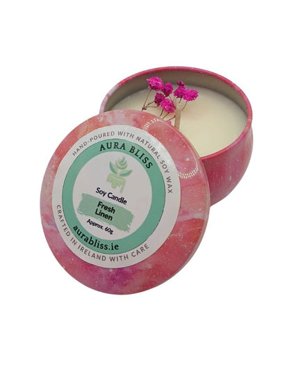 Aura Bliss soy candle in a decorative pink container with a label on a white background