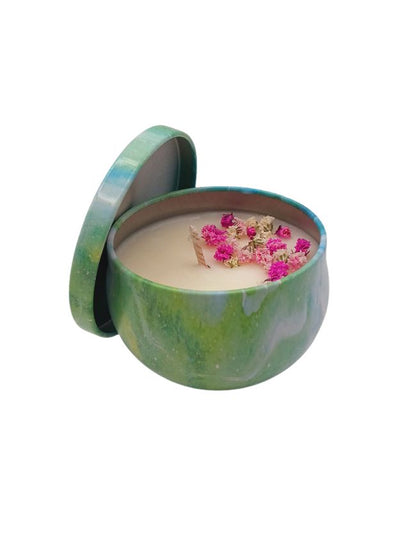 Green marbled candle tin with a candle inside featuring pink flowers on a white background