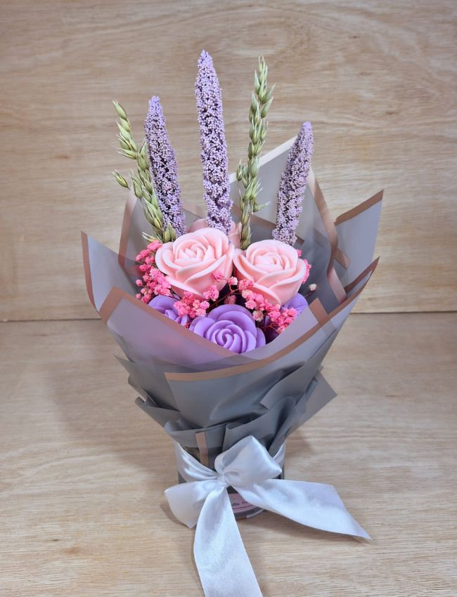 Purple and lilac soy wax candle bouquet, wrapped for gifting.
