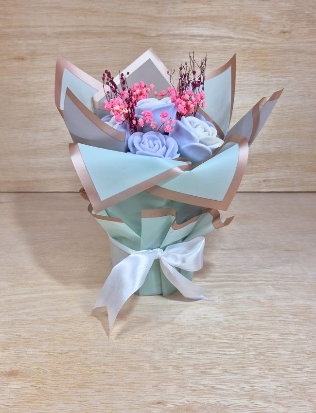Handcrafted soy wax candle bouquet with pink and blue tones.