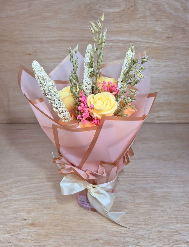 Wrapped bouquet of pastel-coloured soy wax flower candles.