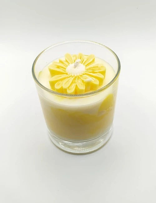 Soy candle with a bold red and white layered design and a delicate floral wax accent.