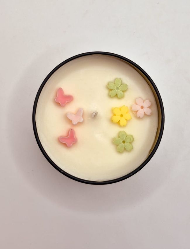 Secret Garden soy candle with dried flower petals.