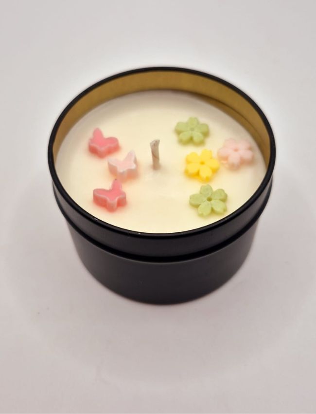 Spring Whimsy scented candle in eco tin, pastel floral design.