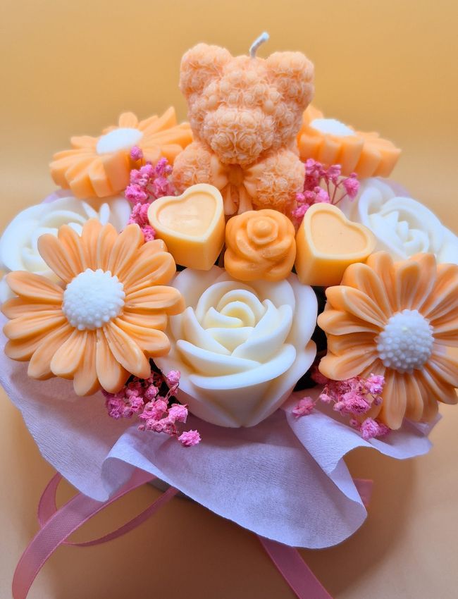 Bright orange and soft yellow soy wax bouquet with layered petals.