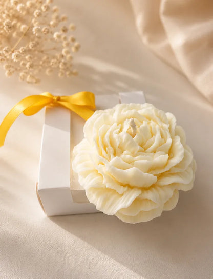 Ivory flower-shaped soy wax candle presented in a white ribbon gift box by AuraBliss