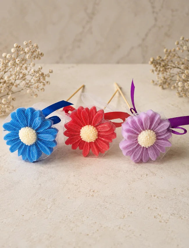 Blue, red and lavender AuraBliss daisy flower candle gifts ready for gifting
