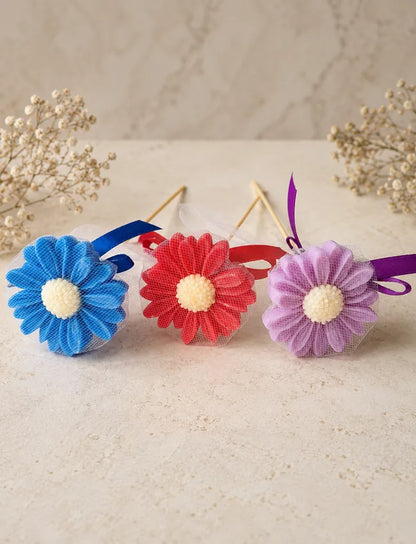 Blue, red and lavender AuraBliss daisy flower candle gifts ready for gifting