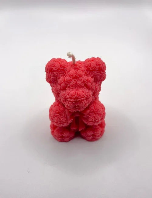 A vibrant red Bear Scented Candle with detailed rose patterns, ideal for romantic settings or as a decorative piece.