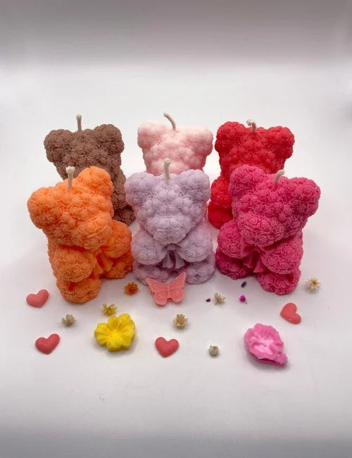 A group of six Bear Scented Candles in vibrant colors (red, pink, orange, purple, light pink, and brown), featuring detailed rose patterns.