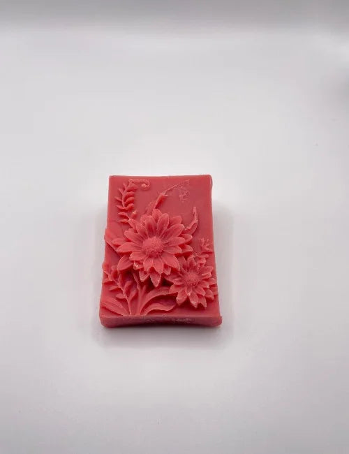 A deep red Blooming Rose soap featuring intricate flower designs, ideal for gentle and nourishing cleansing.