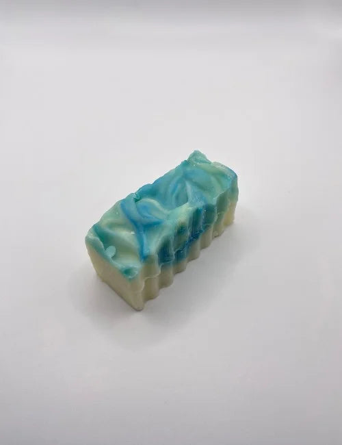 A vibrant citrus and mint soap bar with a textured design, ideal for energizing and refreshing natural skincare.