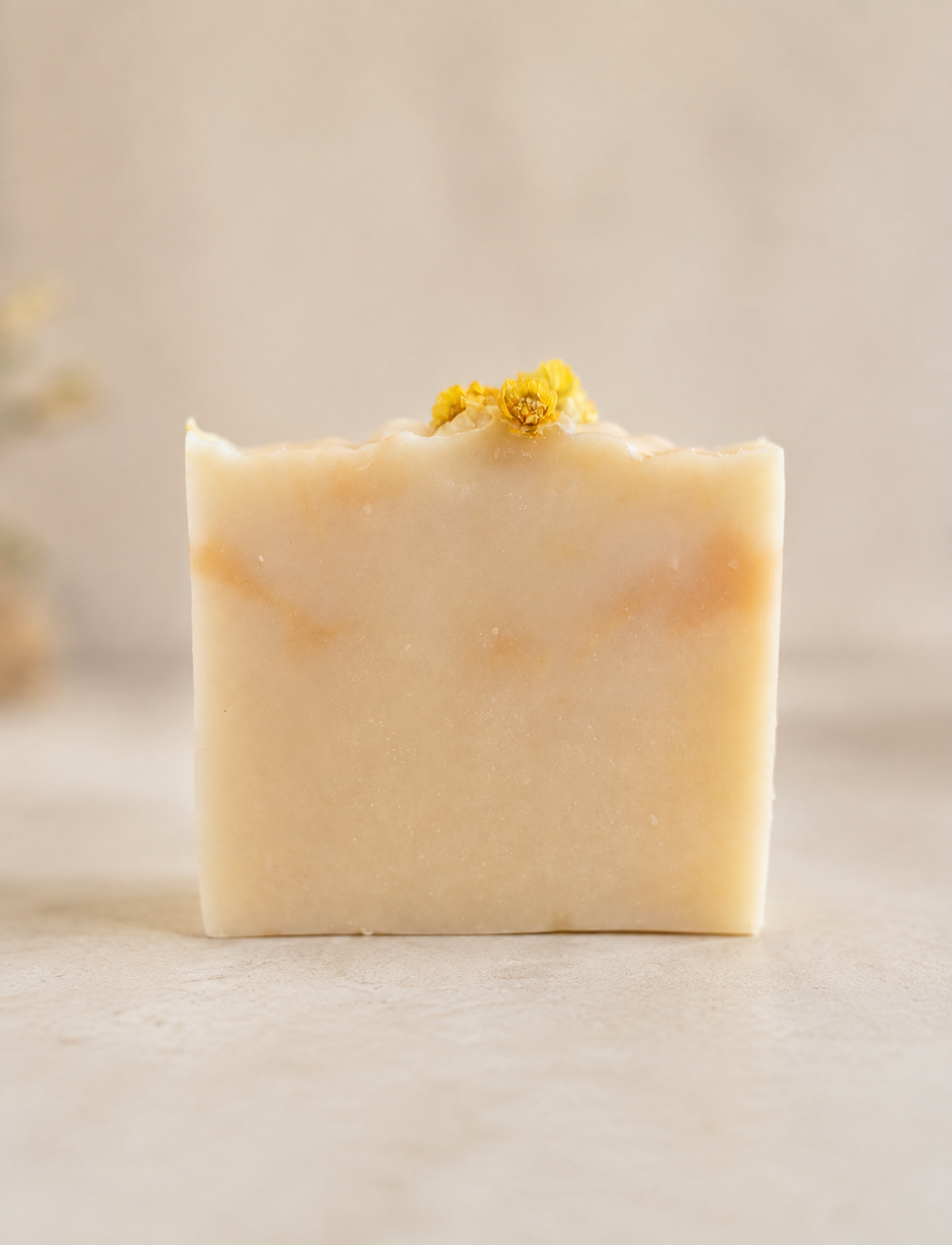 Front view of Eternal Mimosa handmade soap with dried yellow flowers