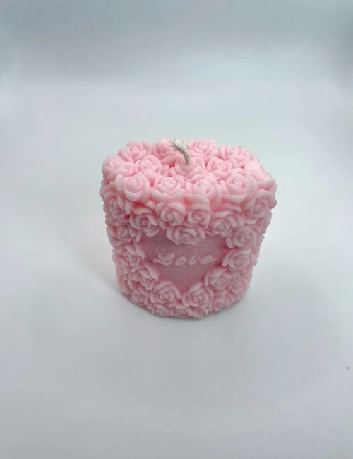 Love candle in soft pink, featuring intricate rose patterns, ideal for weddings, romantic events, or home decoration.