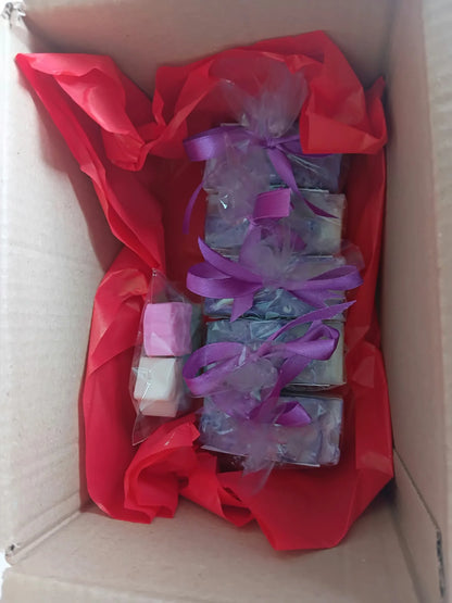 Individually wrapped soap bars packed in a cardboard box with red tissue paper