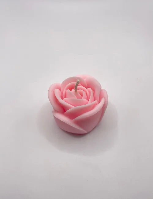 A soft pink rose-shaped candle, perfect for romantic evenings, weddings, and decorative accents.