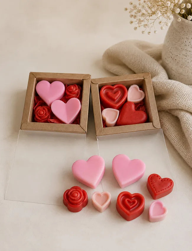 Open kraft gift boxes with pink and red heart and rose wax melts
