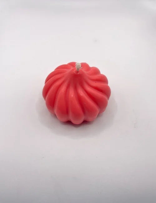 Pumpkin Charm candle in vibrant red, with a unique textured pumpkin shape.