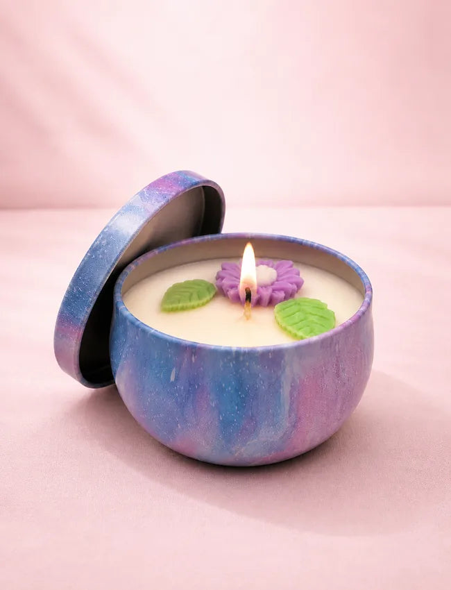 Violet Peony Bloom Wild Violet Peony soy candle in a blue and purple marbled tin with purple flower and green leaf wax decorations