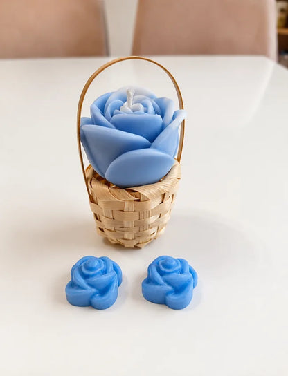Blue rose candle arranged in a small woven basket with two blue flower wax melts