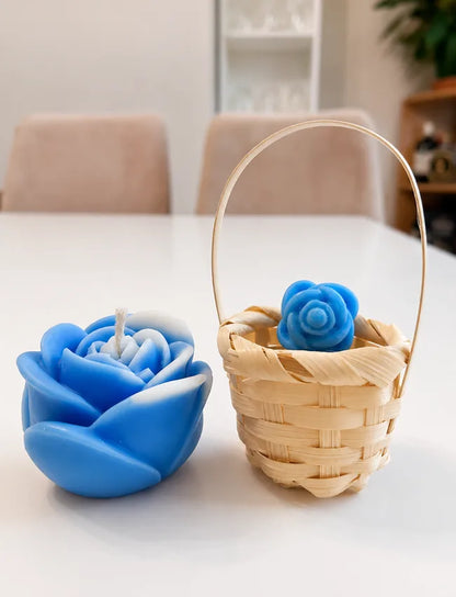 Blue rose candle beside a small woven basket holding a blue flower wax melt