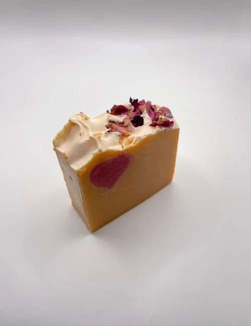 A rose-scented soap bar with a floral heart detail, perfect for luxurious and natural skincare.