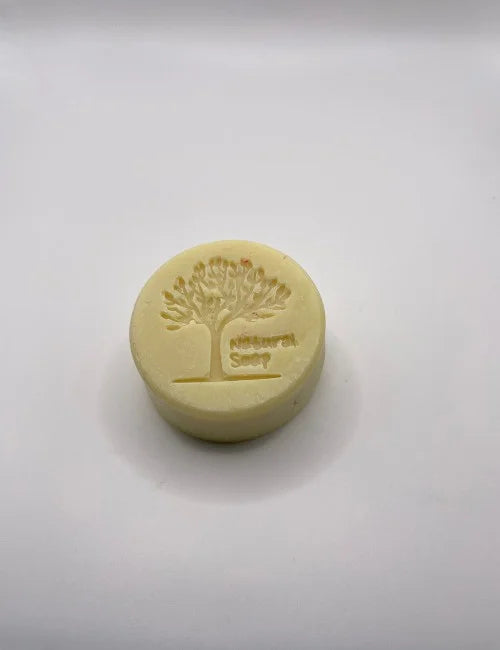 A yellow Simply Natural round soap featuring a tree stamp, perfect for gentle and hydrating skincare.