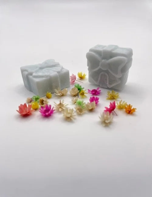 Soft blue wax melt gift box paired with vibrant floral elements.