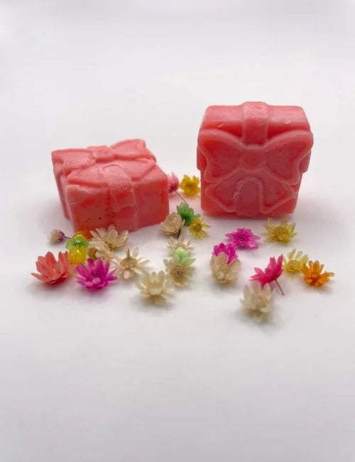 Vibrant red wax melt gift box adorned with colorful flowers.