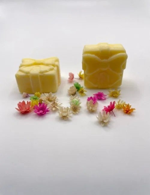 Cheerful yellow wax melt gift box with floral detailing.