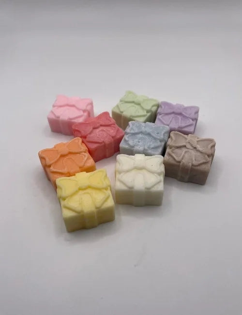 Mixed-colored wax melt gift boxes in a colorful display.